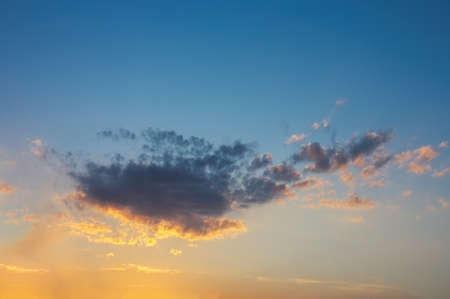 Evening sky in the picturesque clouds, lit by the rays of the setting sun.の写真素材