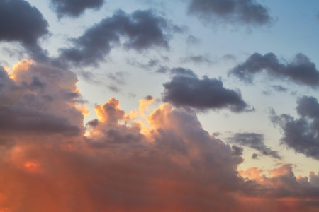 Evening sky in the picturesque clouds, lit by the rays of the setting sun.の写真素材