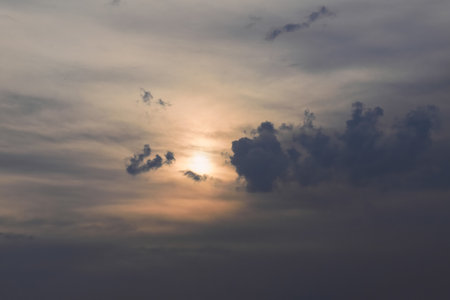 Evening sky in the picturesque clouds, lit by the rays of the setting sun.の写真素材
