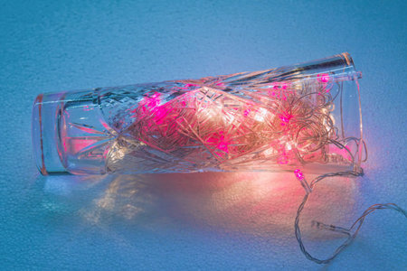 Burning LED Christmas garland in a crystal vase.