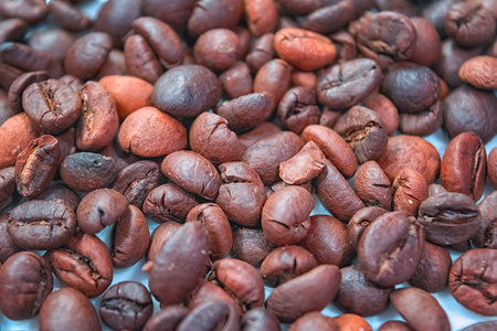 Textured background of freshly roasted coffee beans.