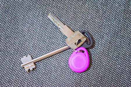 A bunch of keys on a light gray background close-up.