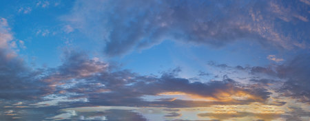 Real amazing panoramic sunrise or sunset sky with gentle colorful clouds.