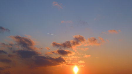 Sunset sky background with tiny clouds. Panoramic image.の写真素材