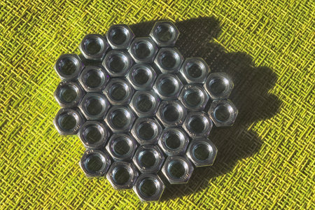 Steel hex nuts on a green background.の写真素材