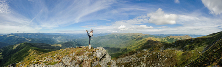 Young woman practices yoga on a mountain top, Carpathian mountainsの写真素材