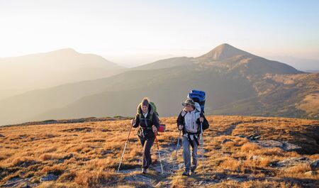 loving couple enjoying the sunset in the mountains