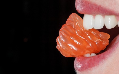 Close-up orange in the woman's mouth. Macroの写真素材