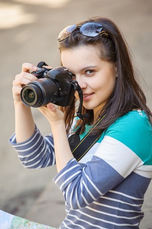 Close-up portrait of beautiful girl with cameraの写真素材