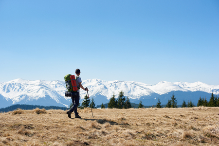 Full length shot of a man tourist with a backpack hiking mountains copyspace landscape view beauty achievement success sport active lifestyle conceptの写真素材