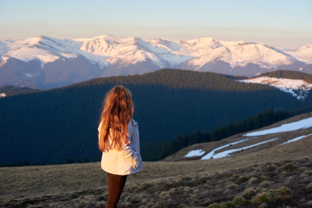 Rearview shot of a woman hiking in the mountains looking around copyspace mature beautiful landscape hiker sportive human lifestyle active conceptの写真素材