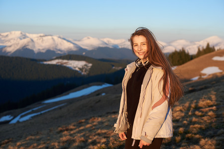 Young beautiful happy woman smiling to the camera while out for a hike in the mountains copyspace happiness activity sporty lifestyle vitality positivity travelling tourism conceptの写真素材