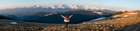 Panoramic. Full length rearview shot of an adventurous female hiker standing on top of the mountain with her arms spread lifestyle vitality happiness achievement hiking travelling natureの写真素材