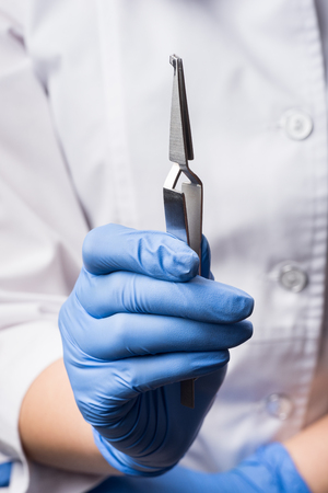 Close-up. Dentist holding reverse tweezers. Orthodontic treatment. Dentistryの写真素材