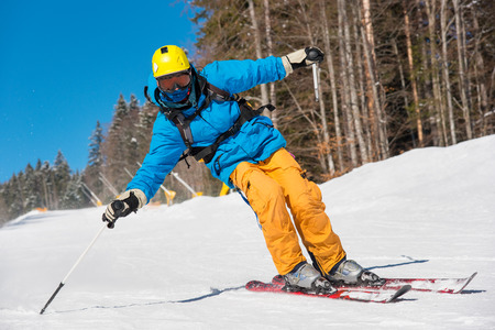 Low angle shot of a professional skier skiing on the slope recreation active sport seasonal resort sportspeople adrenaline extreme conceptの写真素材