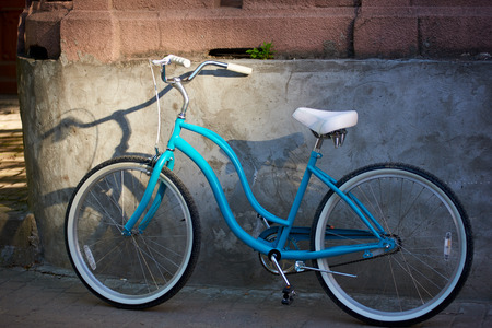 Blue bicycle near the wall of a building in the city center urban leisure lifestyle living transportation vehicle activity summertime voyage trip cycling.の写真素材