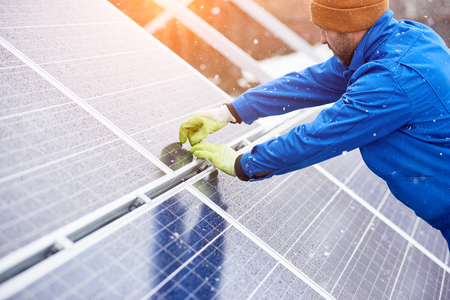 Male electrician worker repairing solar panels outdoors alternative energy source environment friendly engineer power plant factory arrangement production equipment photovoltaic generation.の写真素材