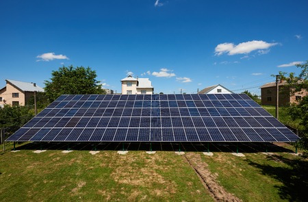 Frontview of big solar panels installed on outdoors opened space. Modern solution for natural resources saving, using renewable solar energy. Environment friendly, green energy. Warm sunny day.の写真素材