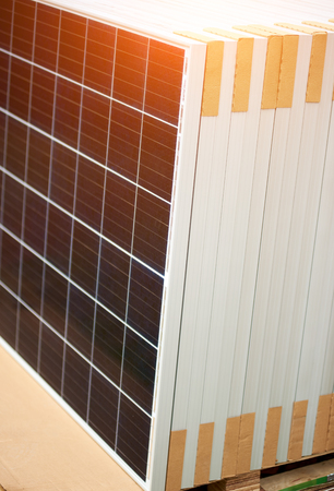 Close-up of new solar photo voltaic modules set ready for buying, transportation and installation. Renewable eco-friendly green energy production and panel system installation concept.の写真素材