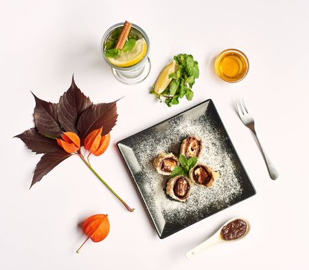 View from above of food flat lay with plants on white tablecloth. Noodles with meet in center decorated with seeds, red and yellow peppers, soya sous and zucchini. Food and vegetable concept.の写真素材