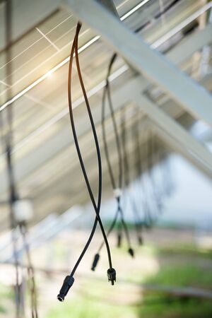 Interior of stand-alone photo voltaic solar system secured on metal rear legs lit by summer sun. Alternative energy, ecology and environment protection and cheap electricity production concept.の写真素材