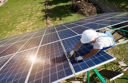 Concentrated mounter installing innovative solar batteries. Modern solution for natural resources saving, using renewable solar energy. Environment friendly, green energy. Ecological . Equipment.の写真素材