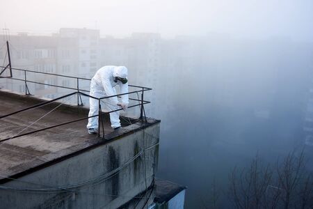 Researcher is evaluating territory on high storey building for his research regarding global pollution disaster, concept of saving the planet. View from aboveの写真素材