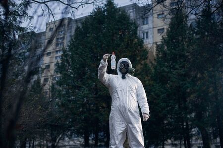Laboratory assistant working in residential area, researching plastic litter, wearing protective...