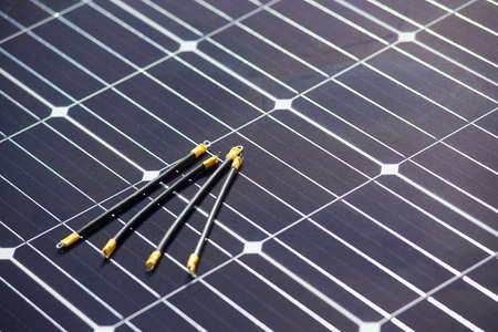 Close-up view of detail for wiring and connecting solar photovoltaic system. Cabels laying on blue solar panelの写真素材