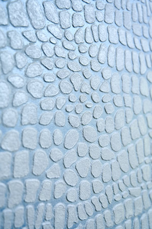 Close-up of light blue color surface similar to snakes skin. Decorative coating for walls, ceilings...