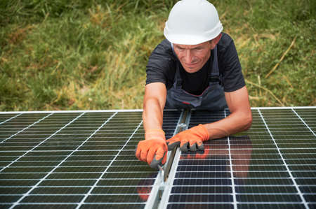 Worker installing solar panel. Renewable and ecological energy. Idea of environment safe. Modern...