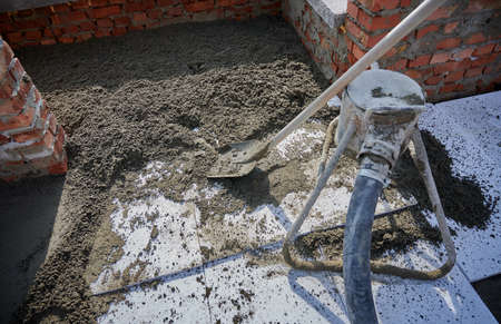 Close up of cement with shovel for construction of walls. Concept of process construction of house...