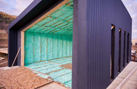 Wooden frame house in the Scandinavian style barnhouse thermal insulated by polyurethane foam. Construction and insulation concept.の写真素材