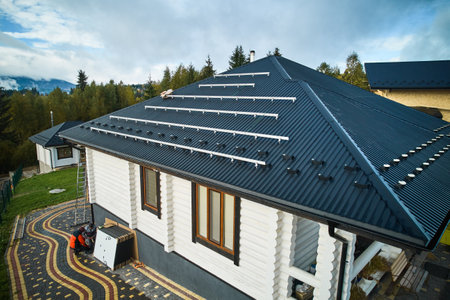 Preparing for installation of solar panels on a roof. Drone view of white wooden house prepared for installing solar batteries on top. Concept of renewable and saving energy.の写真素材