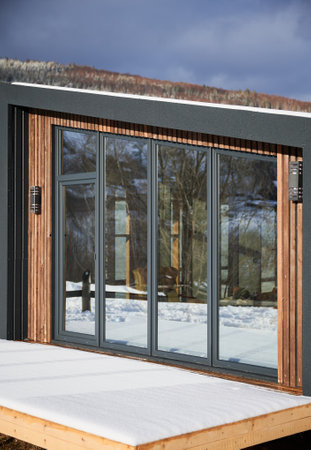 Barn house. Wooden small house in Scandinavian modern style with large windows. Exterior.の写真素材