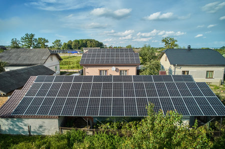 Aerial top view of new modern house cottage with solar photovoltaic panel system on house roofの写真素材