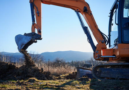 Excavator excavate earth at construction site in the evening.の写真素材