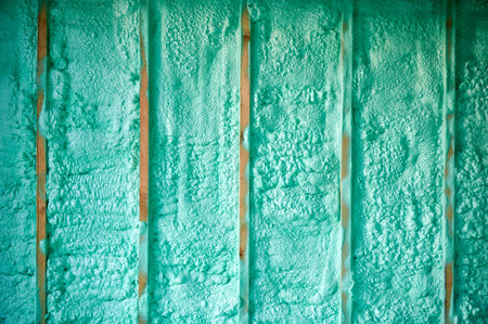 Cropped view of wall in wooden frame house thermal insulated by polyurethane foam. Construction and...