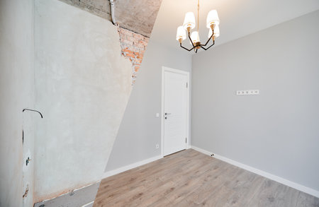Photo collage of apartment room before and after restoration or refurbishment. Old room with doorway and new renovated living room with parquet floor and elegant interior design.の写真素材