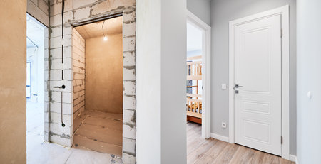 Old apartment with brick walls and new renovated flat doors, room and elegant interior design. Comparison of apartment before and after restoration. Home renovation concept.の写真素材