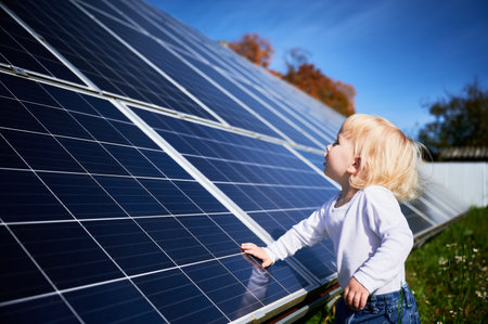 Curious boy investigating how solar battery works. Little kid wondering what solar panel is. Alternative sources of energy for future generationsの写真素材