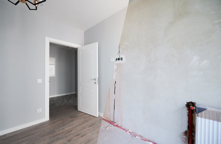 Photo collage of apartment room before and after restoration or refurbishment. Old room with doorway and new renovated living room with parquet floor and elegant interior design.の写真素材