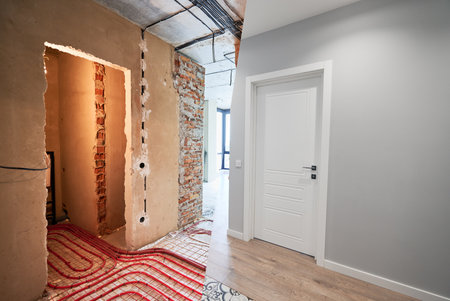 Comparison of old apartment before restoration and new renovated flat with modern interior design. Apartment with underfloor heating pipes before and after renovation.の写真素材