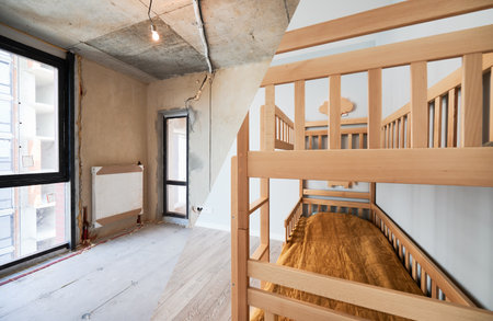 Comparison of children room with wooden bunk bed before and after restoration. Old apartment room with brick wall and new renovated flat with parquet floor and kid house bed.の写真素材