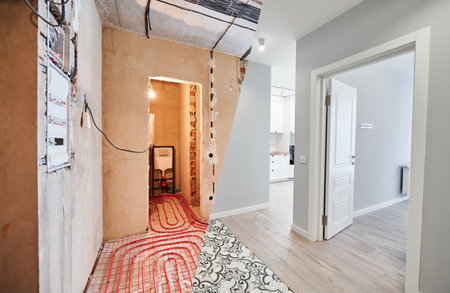 Comparison of old flat with underfloor heating pipes and new renovated apartment with modern interior design. Bathroom, hallway with heated floor before and after renovation.の写真素材