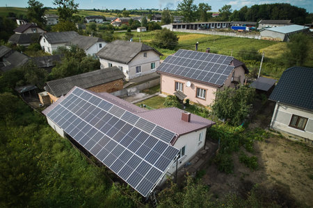 Aerial top view of new modern house cottage with solar photovoltaic panel system on house roofの写真素材