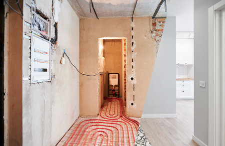 Comparison of old flat with underfloor heating pipes and new renovated apartment with modern interior design. Bathroom, hallway with heated floor before and after renovation.の写真素材
