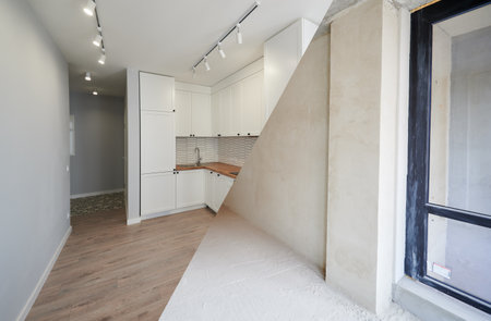 Modern apartment before and after restoration or refurbishment. Comparison of old kitchen room and new place with parquet floor, kitchen counter and white walls. Home renovation concept.の写真素材