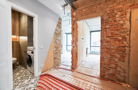 Comparison of old apartment before restoration and new renovated flat with modern interior design. Apartment with underfloor heating pipes and washing machine in bathroom before and after renovation.の写真素材