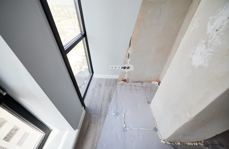 Comparison of apartment flat before and after restoration or refurbishment. Photo collage of old room with large windows and new renovated room with parquet floor and white walls.の写真素材
